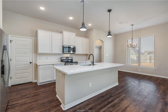 3429 Alsace Ct, Bryan, TX 77808 - kitchen with appliances with stainless steel finishes, arched walkways, dark wood-style flooring, decorative backsplash, and recessed lighting