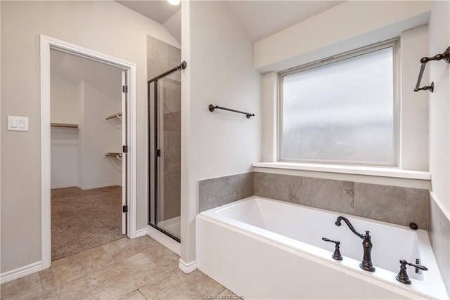 3429 Alsace Ct, Bryan, TX 77808 - bathroom featuring a walk in closet, a stall shower, a garden tub, and lofted ceiling