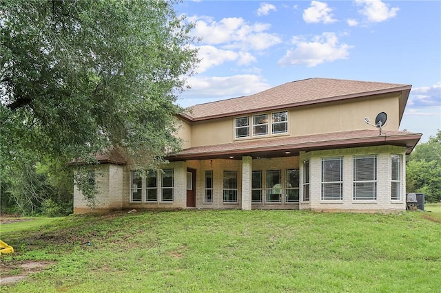 4886 Burt Rd, Bryan, TX 77807 - back of property featuring a lawn, central AC unit, and brick siding