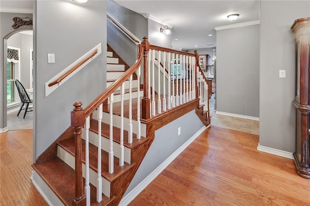 4886 Burt Rd, Bryan, TX 77807 - stairway with ornamental molding, arched walkways, wood finished floors, baseboards, and recessed lighting