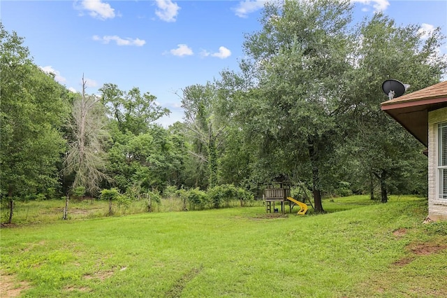 4886 Burt Rd, Bryan, TX 77807 - view of grassy yard with a playground
