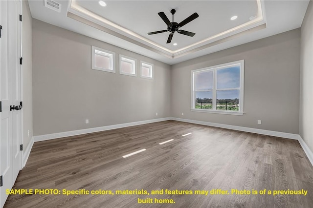 4760 Coral River Rd, College Station, TX 77845 - empty room with a ceiling fan, visible vents, a healthy amount of sunlight, and a raised ceiling