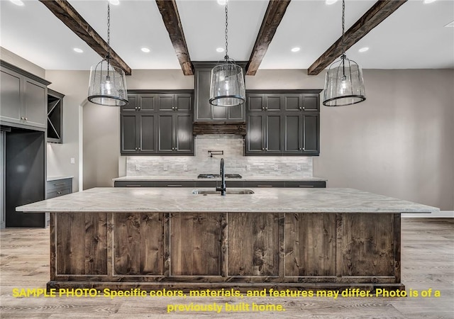 4760 Coral River Rd, College Station, TX 77845 - kitchen featuring a sink, beam ceiling, and light wood-style flooring