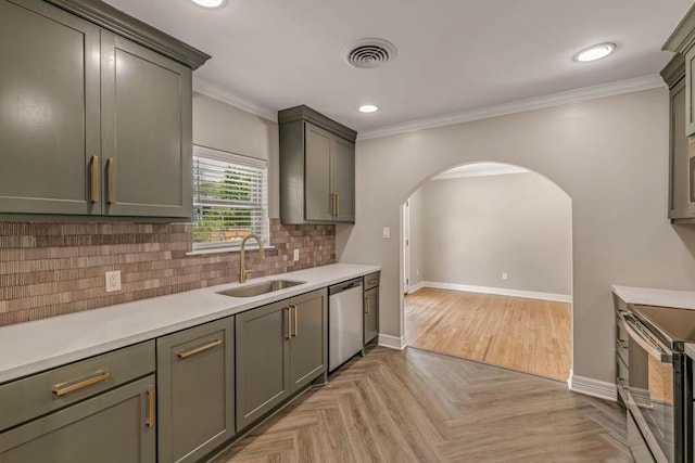 kitchen with stainless steel appliances, backsplash, light parquet flooring, ornamental molding, and sink