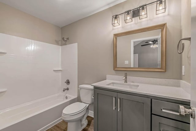 full bathroom with toilet, shower / bath combination, hardwood / wood-style flooring, ceiling fan, and vanity