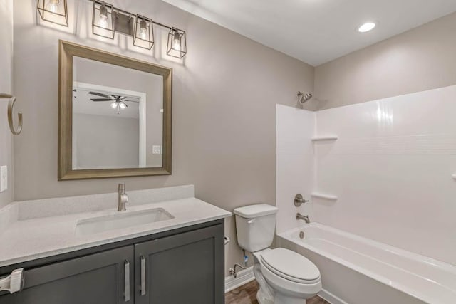 full bathroom featuring bathing tub / shower combination, wood-type flooring, vanity, toilet, and ceiling fan