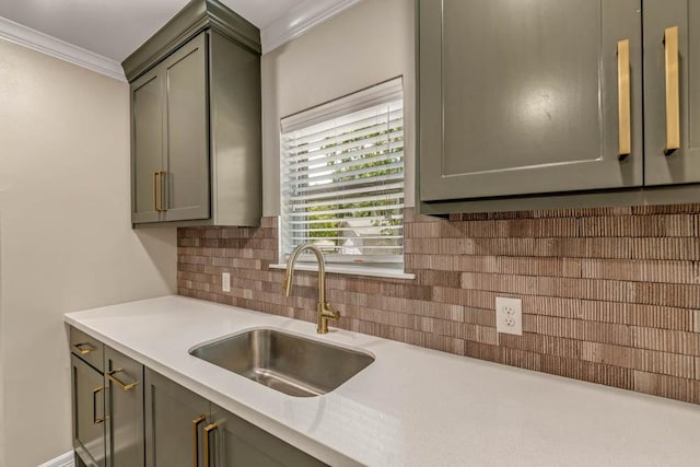 kitchen featuring ornamental molding, backsplash, and sink