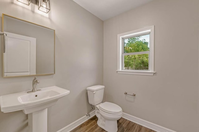 bathroom with sink, wood-type flooring, and toilet