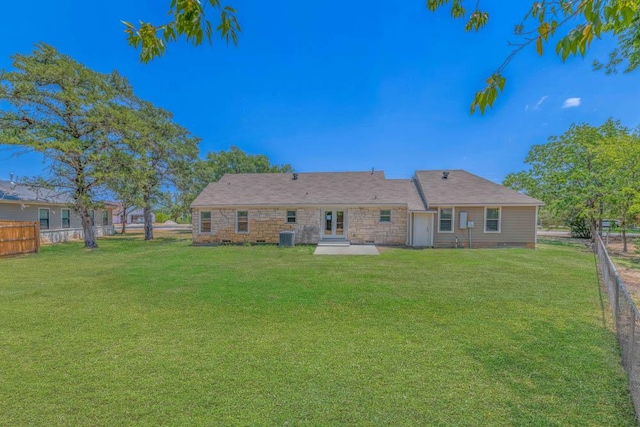 back of house featuring a lawn and a patio