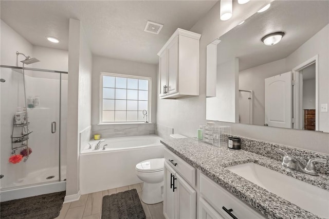 full bathroom with vanity, toilet, a textured ceiling, and independent shower and bath