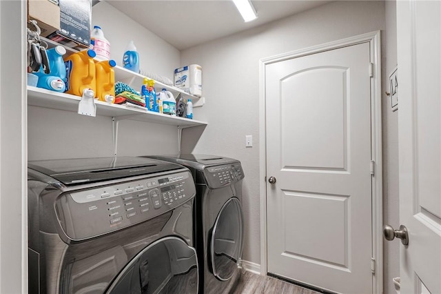 laundry room featuring washer and clothes dryer and hardwood / wood-style flooring