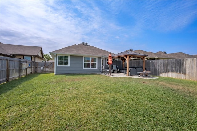 back of property with a gazebo, a patio area, a yard, and a hot tub