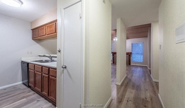 hall with sink and light wood-type flooring