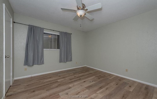 spare room featuring ceiling fan and light wood-type flooring