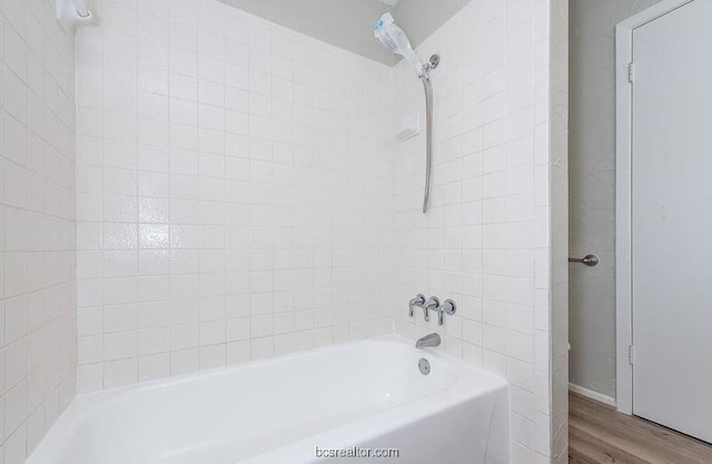 bathroom featuring hardwood / wood-style floors and tiled shower / bath combo