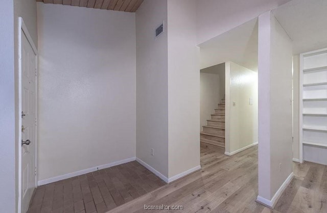 interior space with light wood-type flooring and high vaulted ceiling