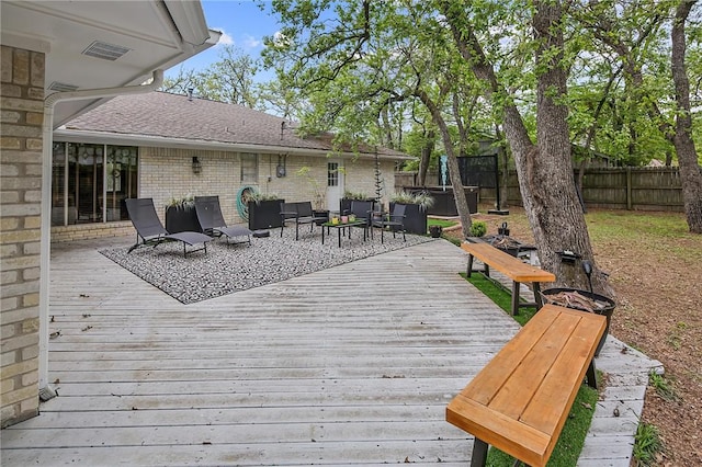 deck featuring an outdoor hangout area and a trampoline