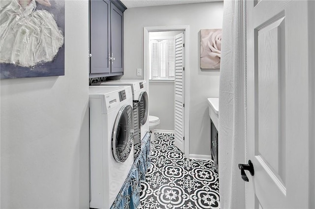 laundry area with cabinets, independent washer and dryer, and tile patterned floors