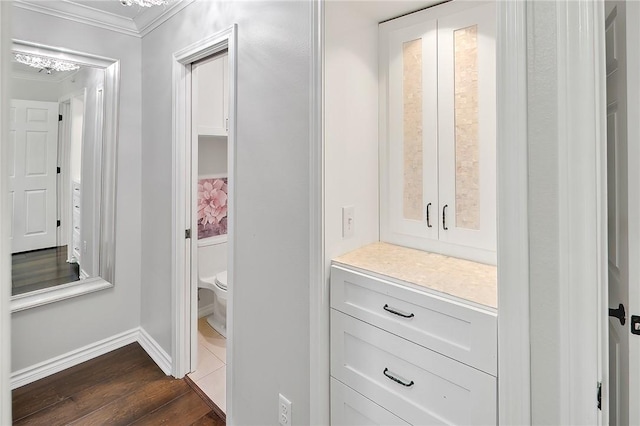 bathroom with crown molding and hardwood / wood-style floors