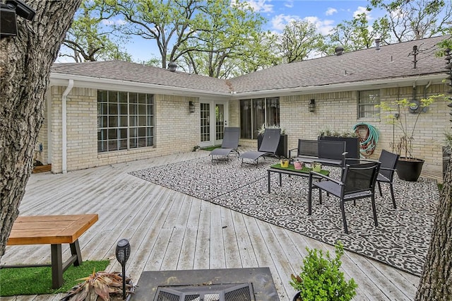 deck featuring outdoor lounge area and french doors