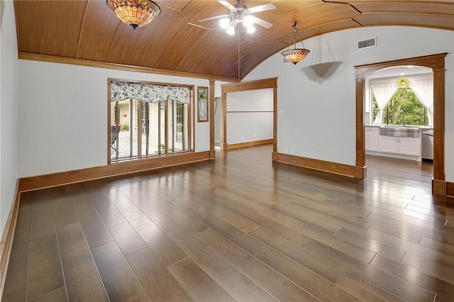 unfurnished room with dark hardwood / wood-style floors, ceiling fan, sink, and vaulted ceiling