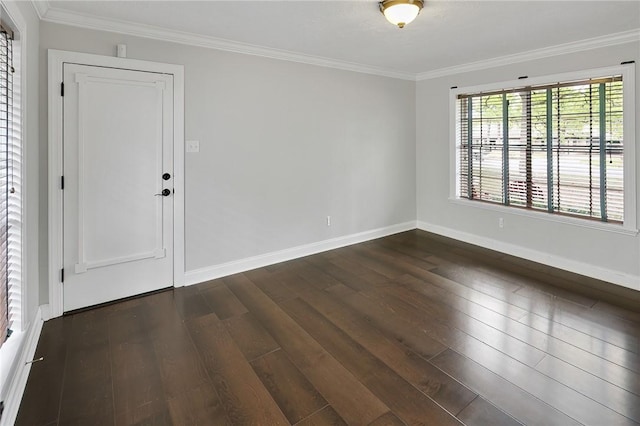 unfurnished room with ornamental molding and dark wood-type flooring