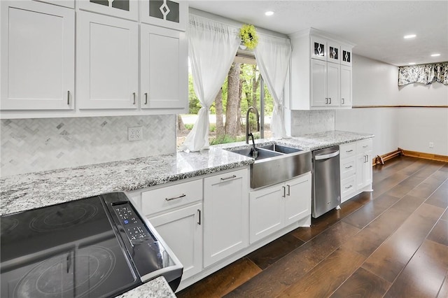 kitchen featuring white cabinetry, sink, dark wood-type flooring, stainless steel dishwasher, and stove