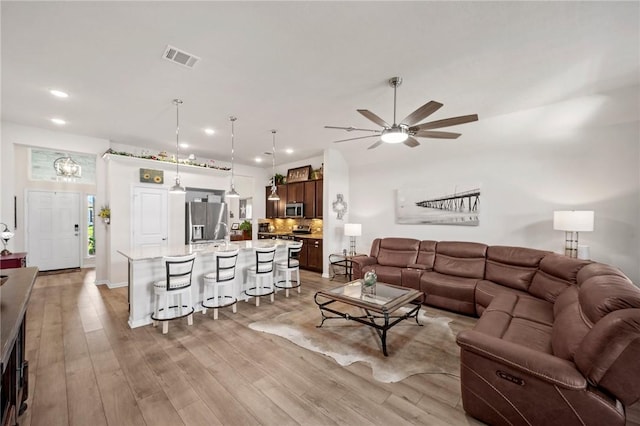 7902 Putter Place Ct, Navasota, TX 77868 - living area with recessed lighting, a ceiling fan, and light wood-type flooring