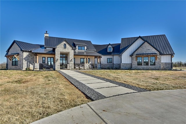 modern farmhouse style home with a front lawn