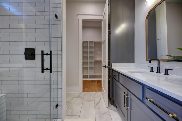 bathroom featuring vanity and a shower with door