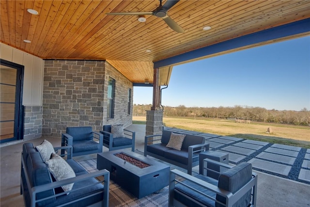 view of patio / terrace with an outdoor living space with a fire pit and ceiling fan