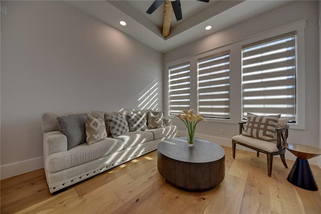 living room featuring ceiling fan, plenty of natural light, and light wood-type flooring