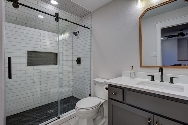 bathroom featuring vanity, walk in shower, ceiling fan, toilet, and tile patterned floors