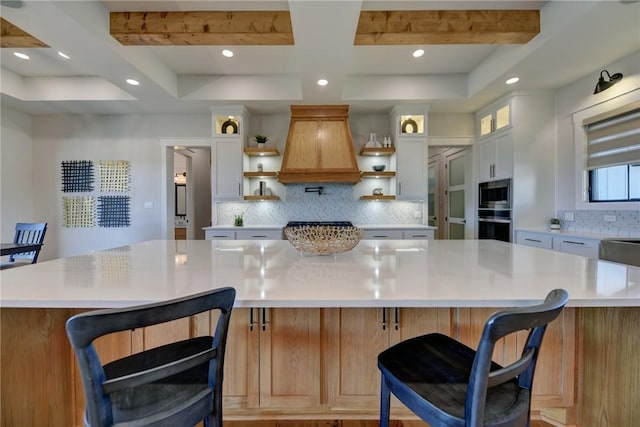 kitchen with a spacious island, appliances with stainless steel finishes, a breakfast bar area, and white cabinets