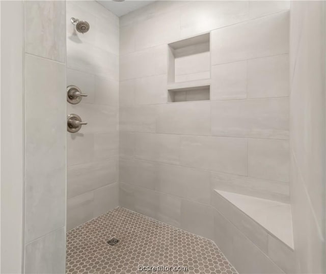 bathroom with tiled shower