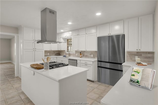 kitchen with a center island, tasteful backsplash, island range hood, white cabinetry, and stainless steel appliances