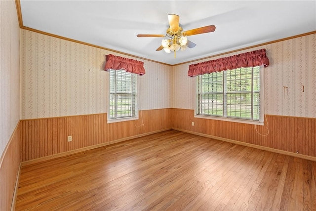 1704 N Pacific St, Conroe, TX 77301 - empty room with hardwood / wood-style flooring, a ceiling fan, wainscoting, and crown molding