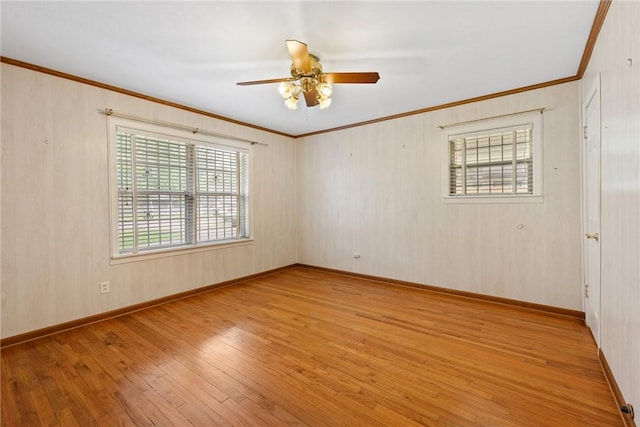 1704 N Pacific St, Conroe, TX 77301 - spare room with hardwood / wood-style flooring, healthy amount of natural light, ornamental molding, a ceiling fan, and baseboards