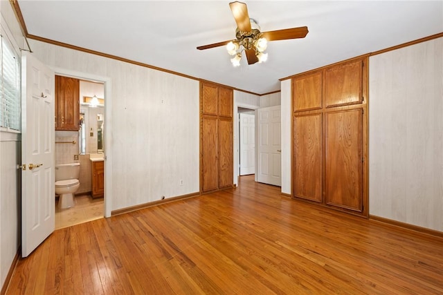 1704 N Pacific St, Conroe, TX 77301 - unfurnished bedroom featuring hardwood / wood-style flooring, ornamental molding, ensuite bath, a closet, and ceiling fan