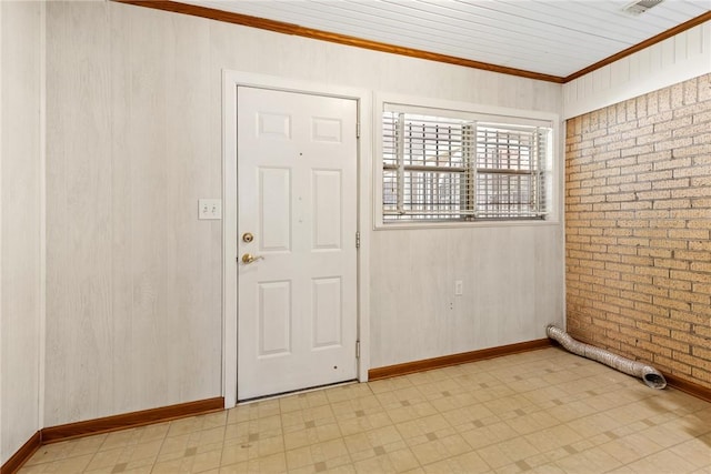 1704 N Pacific St, Conroe, TX 77301 - spare room with light floors, ornamental molding, brick wall, and baseboards