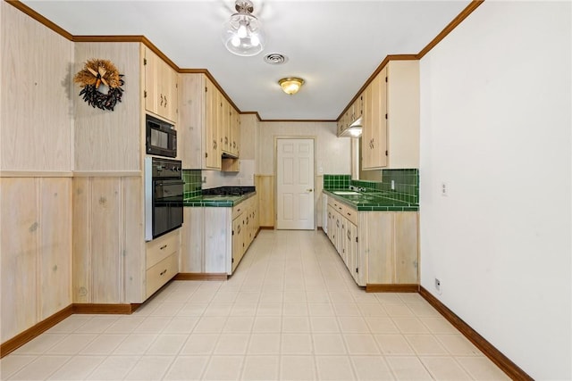 1704 N Pacific St, Conroe, TX 77301 - kitchen featuring black appliances, tile countertops, backsplash, baseboards, and a sink