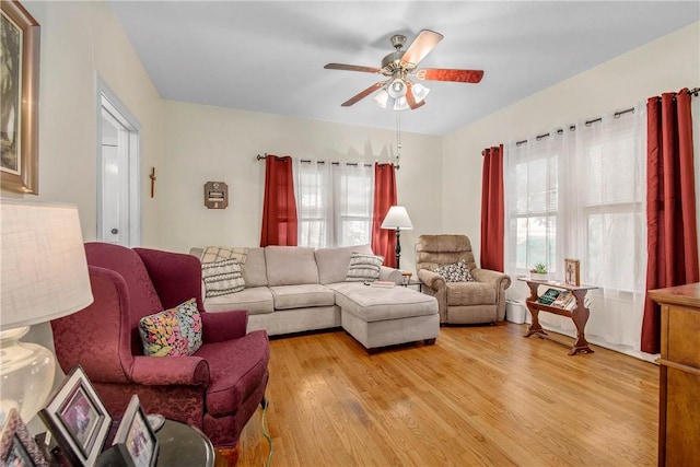 living room with light wood-style floors and ceiling fan