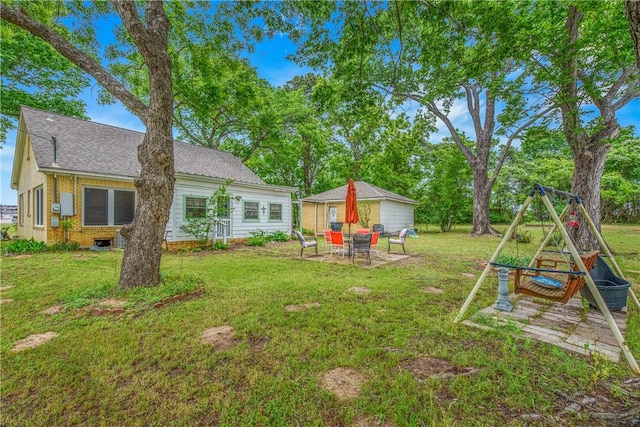 view of grassy yard with a patio