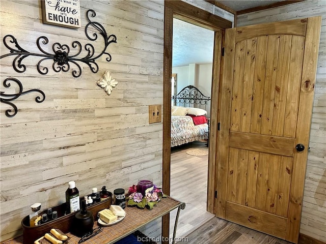 mudroom with wood-type flooring and wooden walls