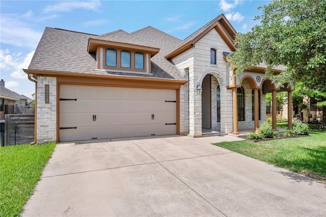 4118 Cedar Creek Ct, College Station, TX 77845 - french country style house featuring driveway, a shingled roof, stone siding, and a garage