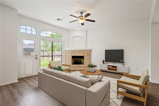 4118 Cedar Creek Ct, College Station, TX 77845 - living room with wood finished floors, ceiling fan, a stone fireplace, and baseboards