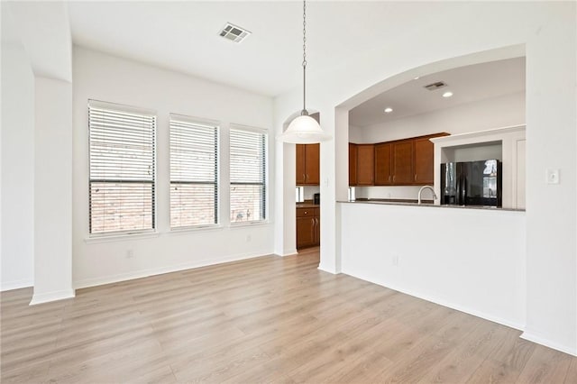 4118 Cedar Creek Ct, College Station, TX 77845 - unfurnished living room with light wood finished floors, arched walkways, recessed lighting, and baseboards