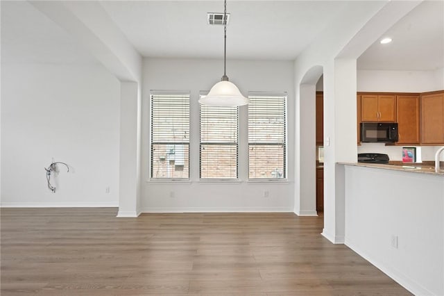 4118 Cedar Creek Ct, College Station, TX 77845 - unfurnished dining area featuring arched walkways, light wood finished floors, recessed lighting, and baseboards