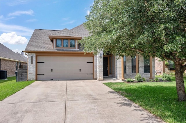 4118 Cedar Creek Ct, College Station, TX 77845 - view of front of home with driveway, a front yard, brick siding, roof with shingles, and cooling unit