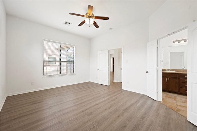4118 Cedar Creek Ct, College Station, TX 77845 - unfurnished bedroom with a sink, light wood finished floors, and baseboards